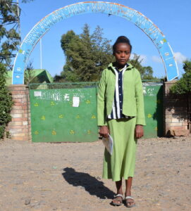 Keneni Asefa Tefera in front of her school, Ethiopia, Africa 2023